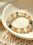 Multicolored beaded bracelet on a white plate with a textured surface