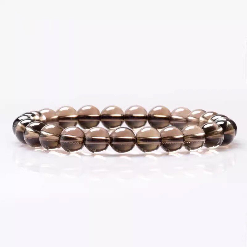 Beaded bracelet with brown and silver beads on a white background