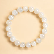 White beaded bracelet on a beige background