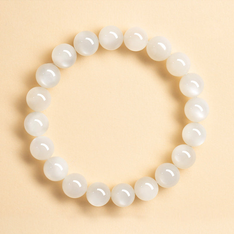 White beaded bracelet on a beige background